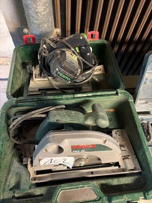 a green box with a circular saw on top of it