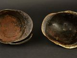 two bowls are sitting next to each other on a black surface