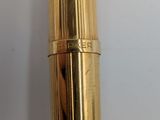 a close up of a gold colored fountain pen with a black nib
