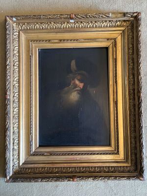 tableau représentant un homme coiffé d'un chapeau et portant une barbe, dans un cadre doré accroché au mur