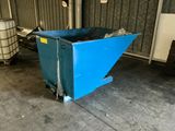 a blue dumpster sitting in a garage next to a metal container
