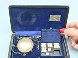 a woman ' s hand that is holding a small device in a case