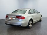 the rear of a silver car is parked in a large room
