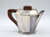 silver teapot with wooden handle on a white background