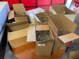 many boxes of glasses on a table in a room