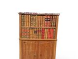 an old wooden bookcase with many books on top of it
