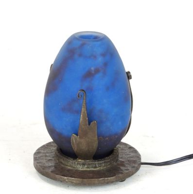 a blue vase with a bird on it on a stand