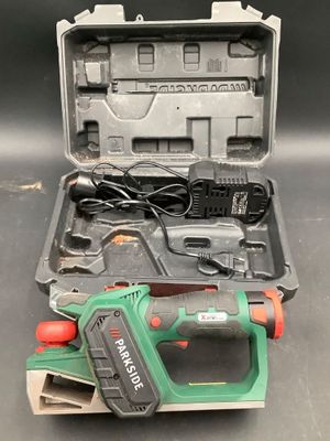 a cordless tool in a case on a table