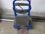 a blue hand truck with a hose attached to it