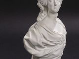 pair of white marble busts of a woman and a man