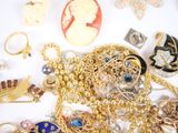 many different types of jewelry on a white surface