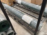 many rolls of metal mesh on a rack in a warehouse