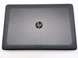 hp laptop on a white table with a black keyboard