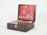 a small wooden box with a bunch of items inside of it