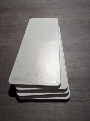 three white plates stacked on top of each other on a table