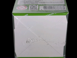 a white box with a green lid on a black background