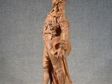 an old statue of a man with a sword and shield