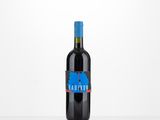 the bottle of red wine is sitting on a white table