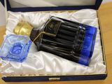 a bottle of perfume sitting in a box on a table