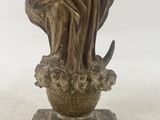 an image of a statue of a woman holding a bird on a pedestal