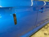 a blue car that has a sticker on the side of it