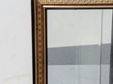 a glass display case with a mirror on the wall