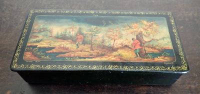 a black box with a painting on it sitting on a table