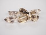 a group of three champagne colored diamond cut stones on a white surface