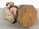 a figurine of a woman sitting on top of a wooden box