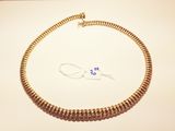 gold plated chain necklace with a clasp on a white surface
