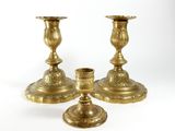 three brass candlesticks on a white background with a white background