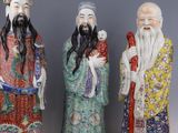 three chinese figurines of men with long hair and beards