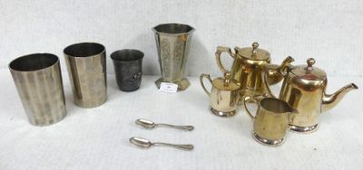 many different types of silverware on a white table