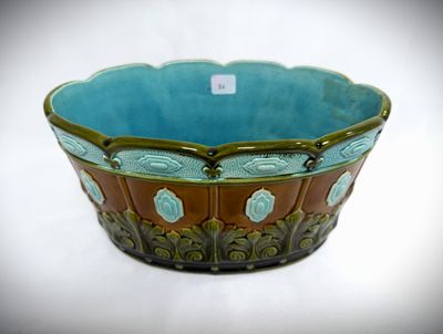 a blue and brown bowl sitting on a white surface