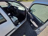 a silver car with its door open on the side of the road