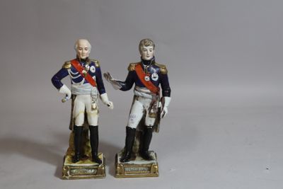 pair of figurines of two men in uniforms with guns