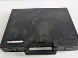 an old black briefcase sitting on top of a white table