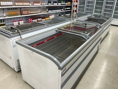 many bottles of wine in the coolers in the store