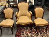 three chairs and a table in a room with a rug