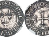 a close up of a coin with a cross on it