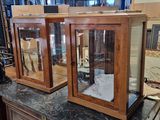 two glass cases on top of a counter in a store