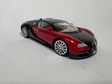a red and black bugatti car on a white surface