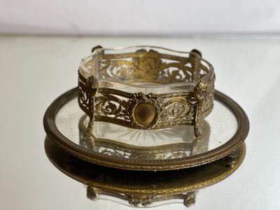 a glass plate with a gold bracelet on it