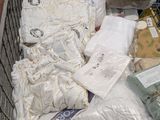 a shopping cart full of bedding and other items