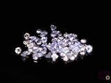 a close up of a bunch of diamonds on a black surface
