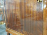 a wooden cabinet that has a drawer on top of it