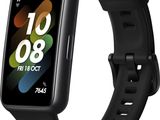 une montre connectée noire avec un bracelet noir sur fond blanc
