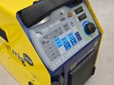 a yellow and blue machine that is sitting on the ground