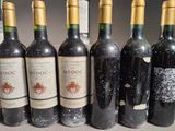 several bottles of wine are lined up in a row on a table