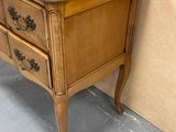 a wooden table with a drawer on it in a room